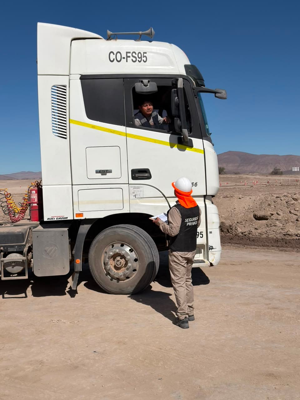 Security guard checking a truck entering a job site checkpoint