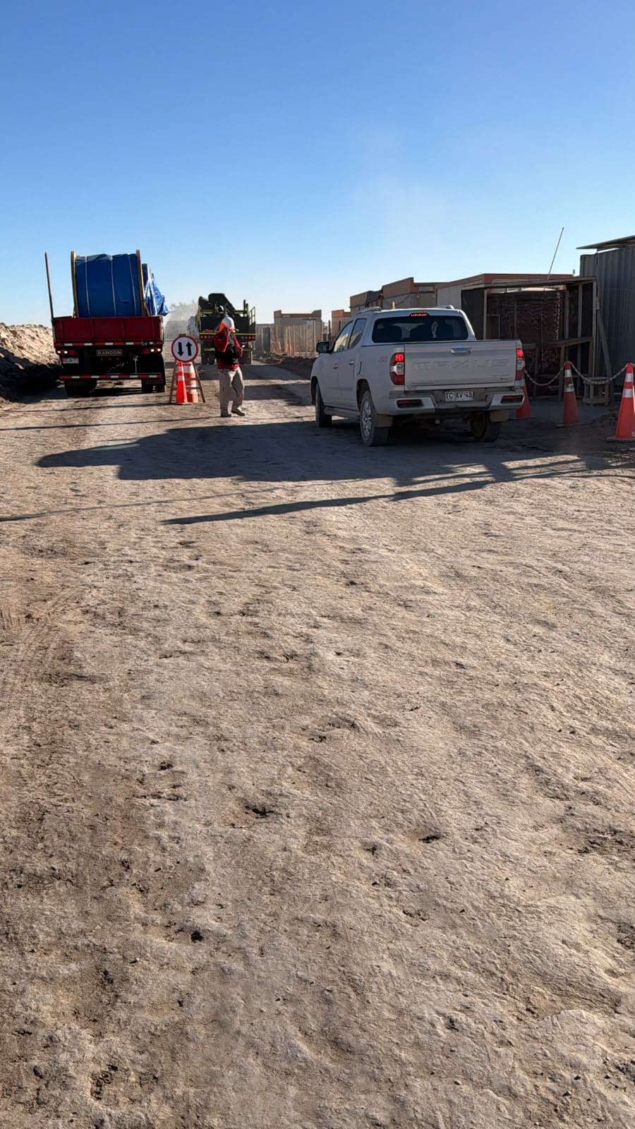 Guard inspecting a truck loaded with precast concrete
